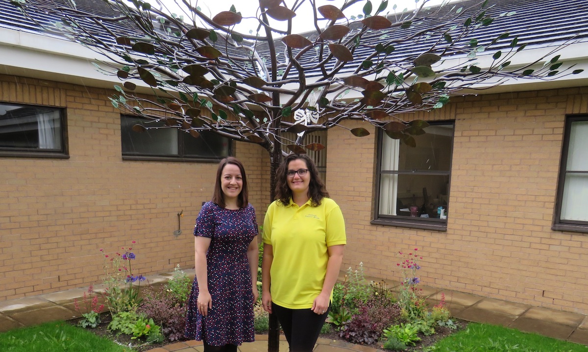 Sarah Greenwood from Airedale Chemical with Dawn Wright, part of Airedale Hospital’s bereavement team, by the ‘Tree of Tranquillity’ in the hospital’s Baby Remembrance Garden copy