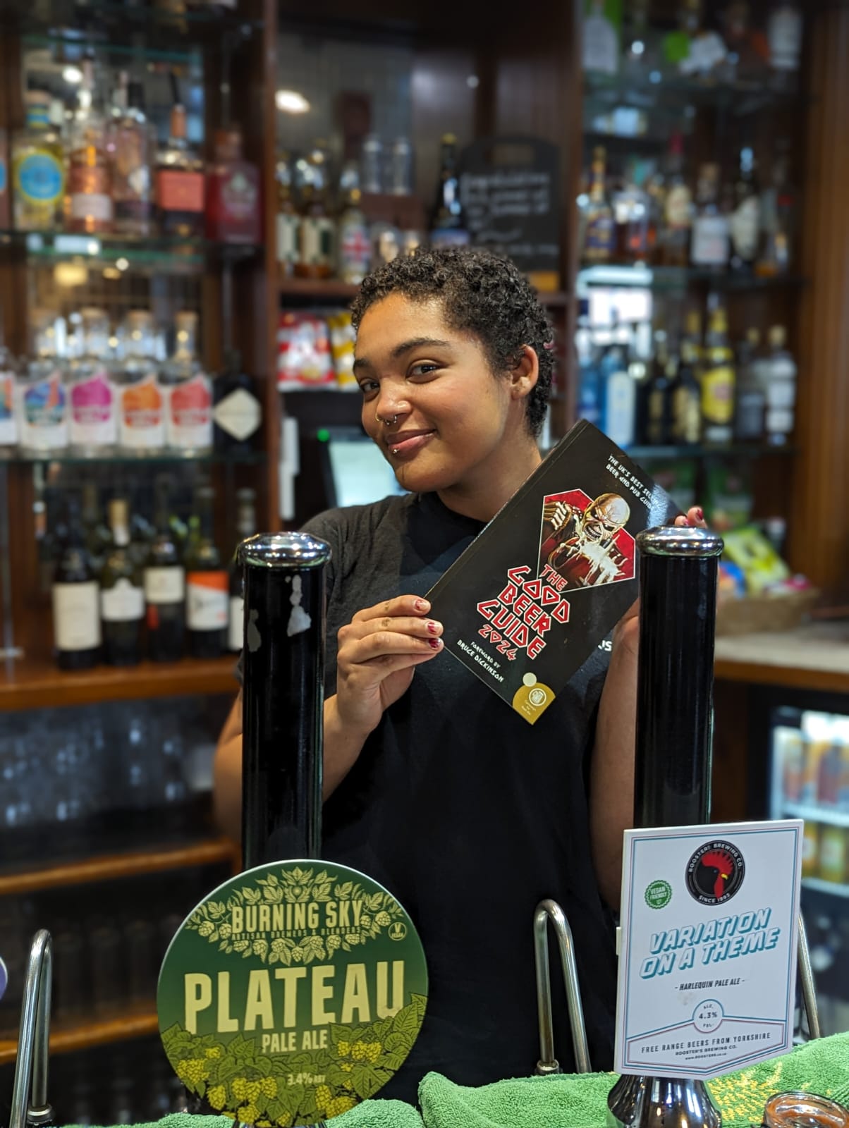 Leah at The Sportsman shows off their entry in the Good Beer Guide